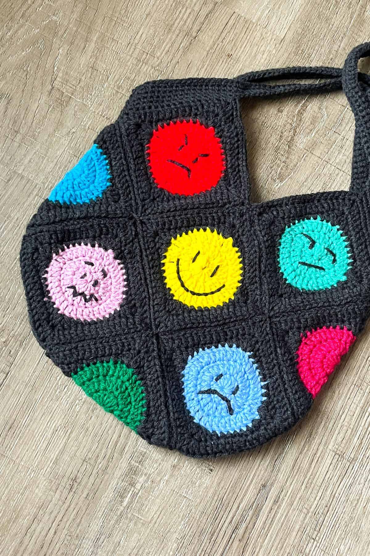 Finished crochet emoji bag pattern.