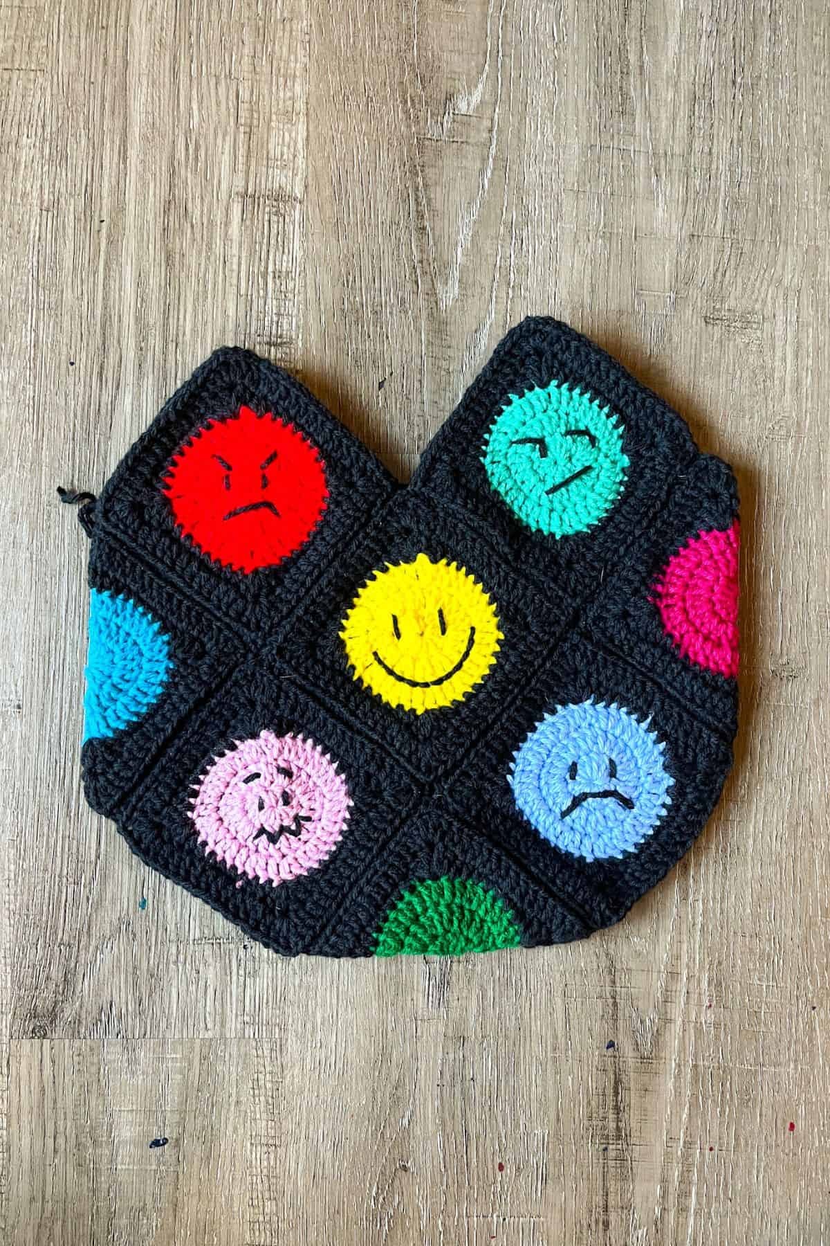 Finished base of the crochet emoji bag minus the handle.