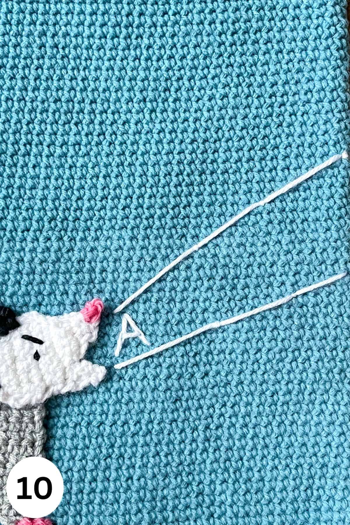 Embroidering on to the crochet bag pattern.