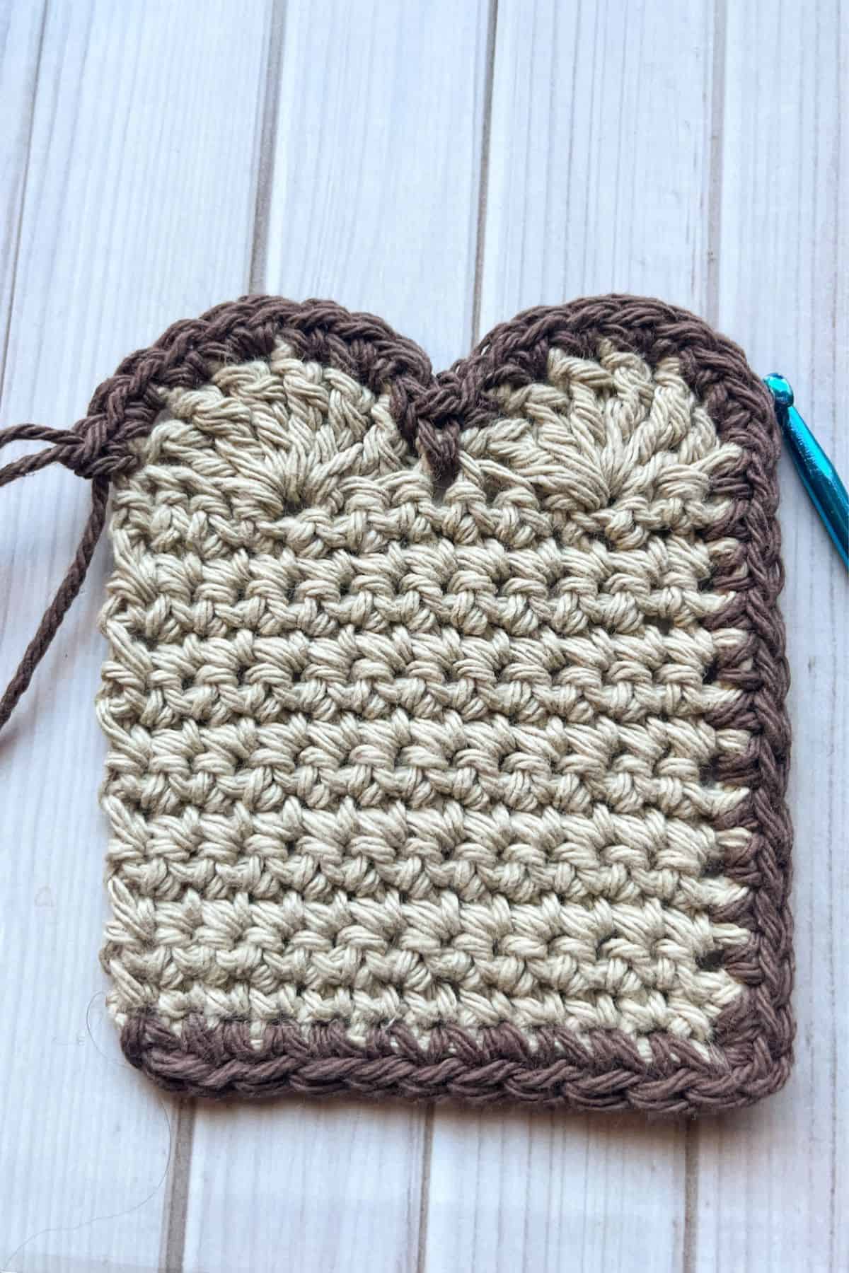 Crocheting the crust on to the crochet slice of bread.