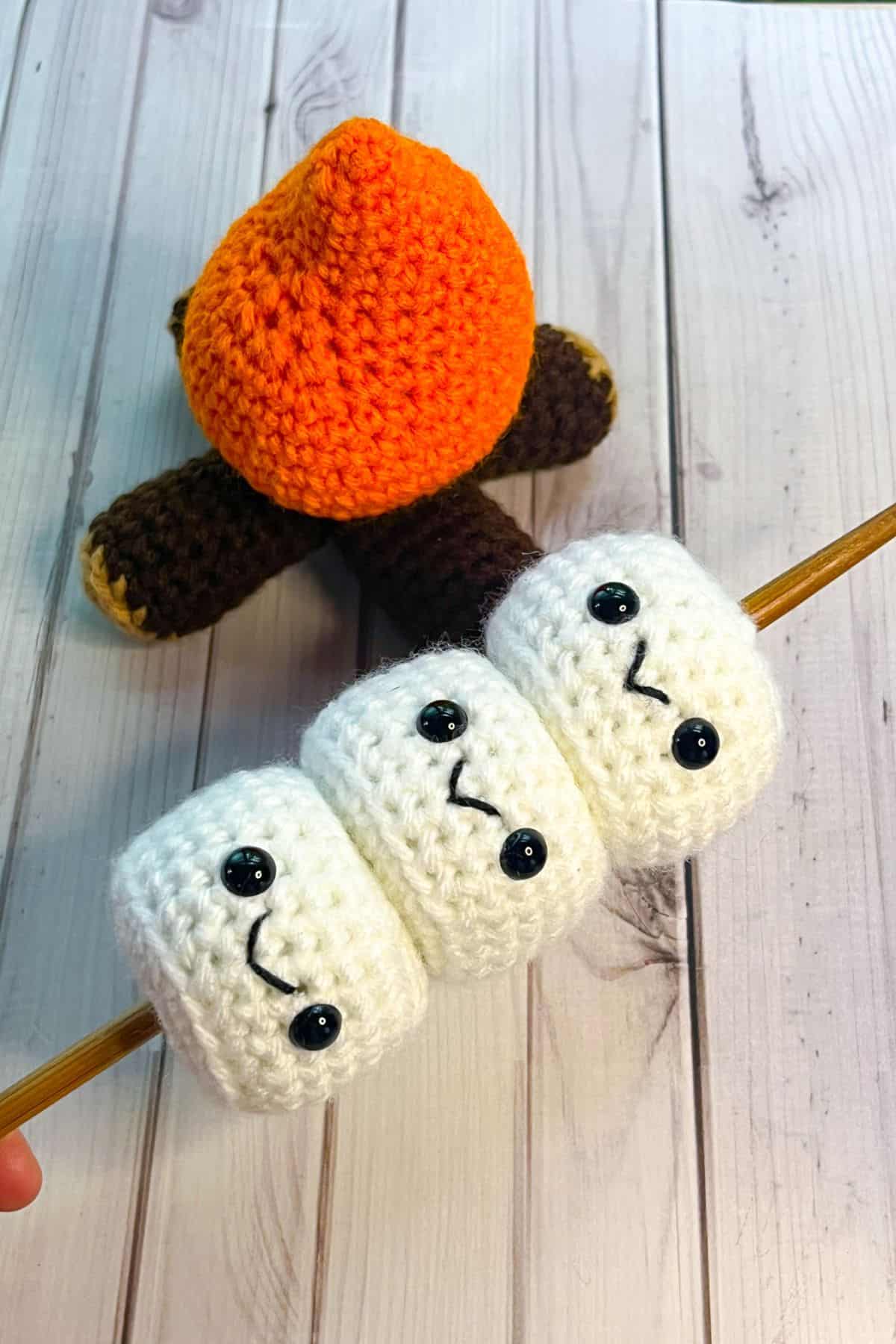 Crochet marshmallows stick with crochet campfire.