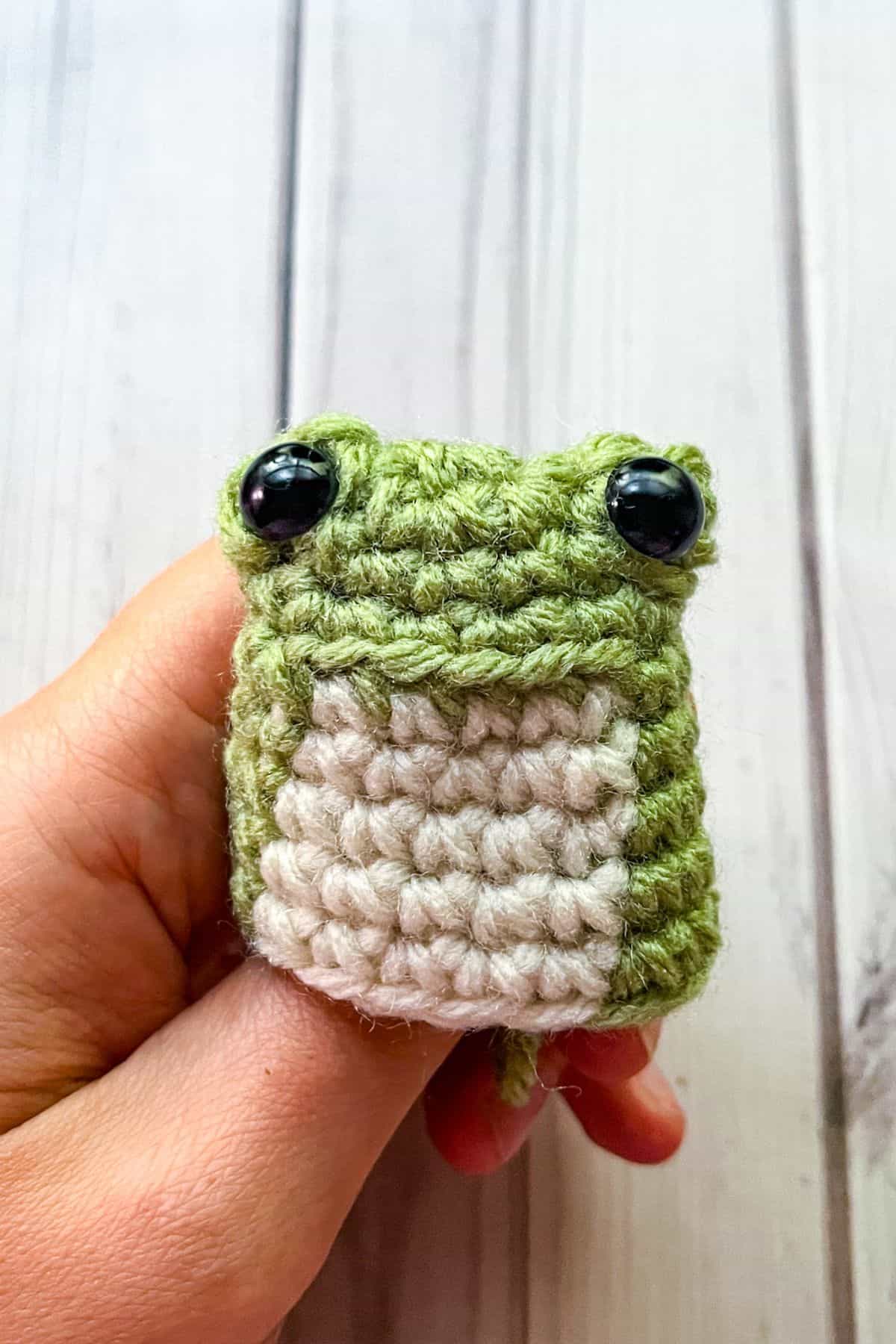 Finishing the body of the crochet frog.