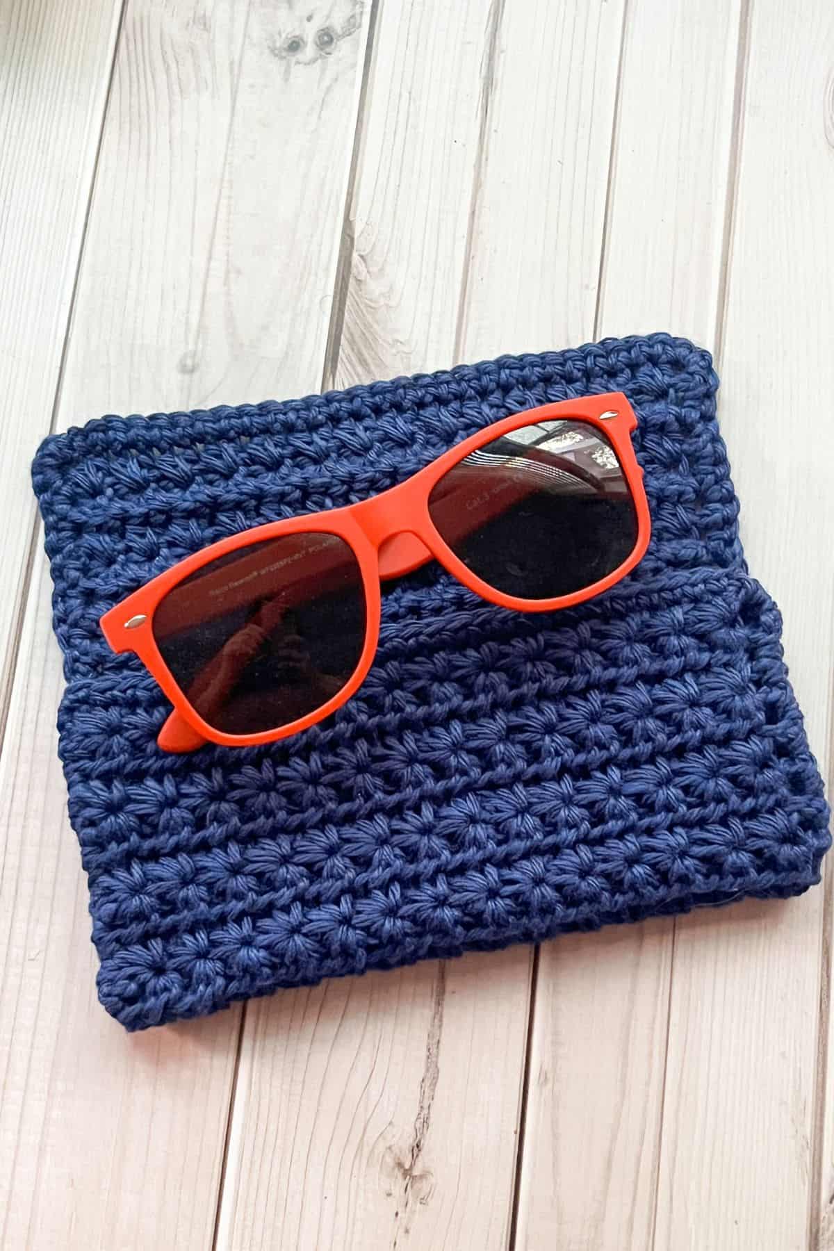 Crochet glasses case with glasses.