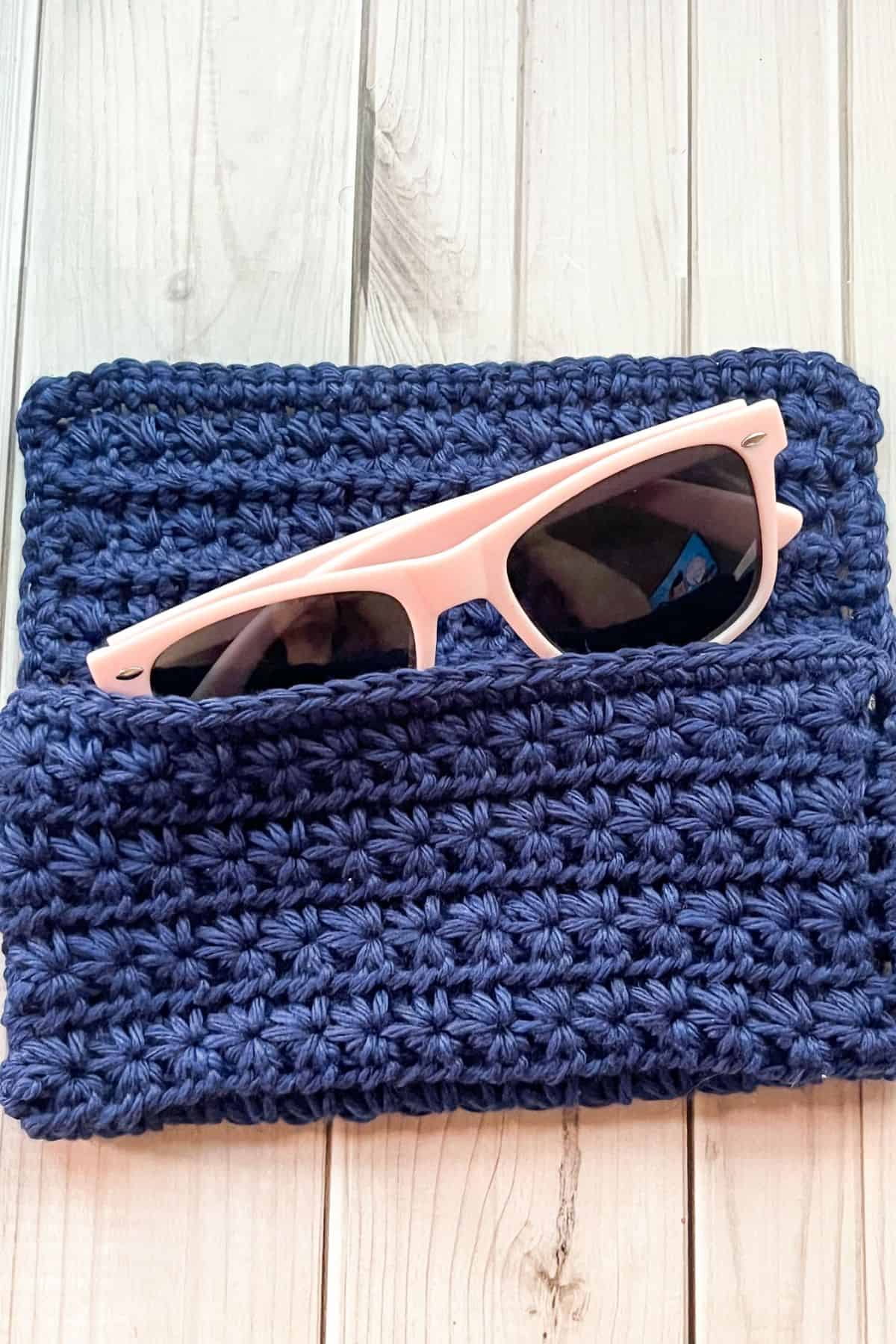 Crochet glasses case with glasses.