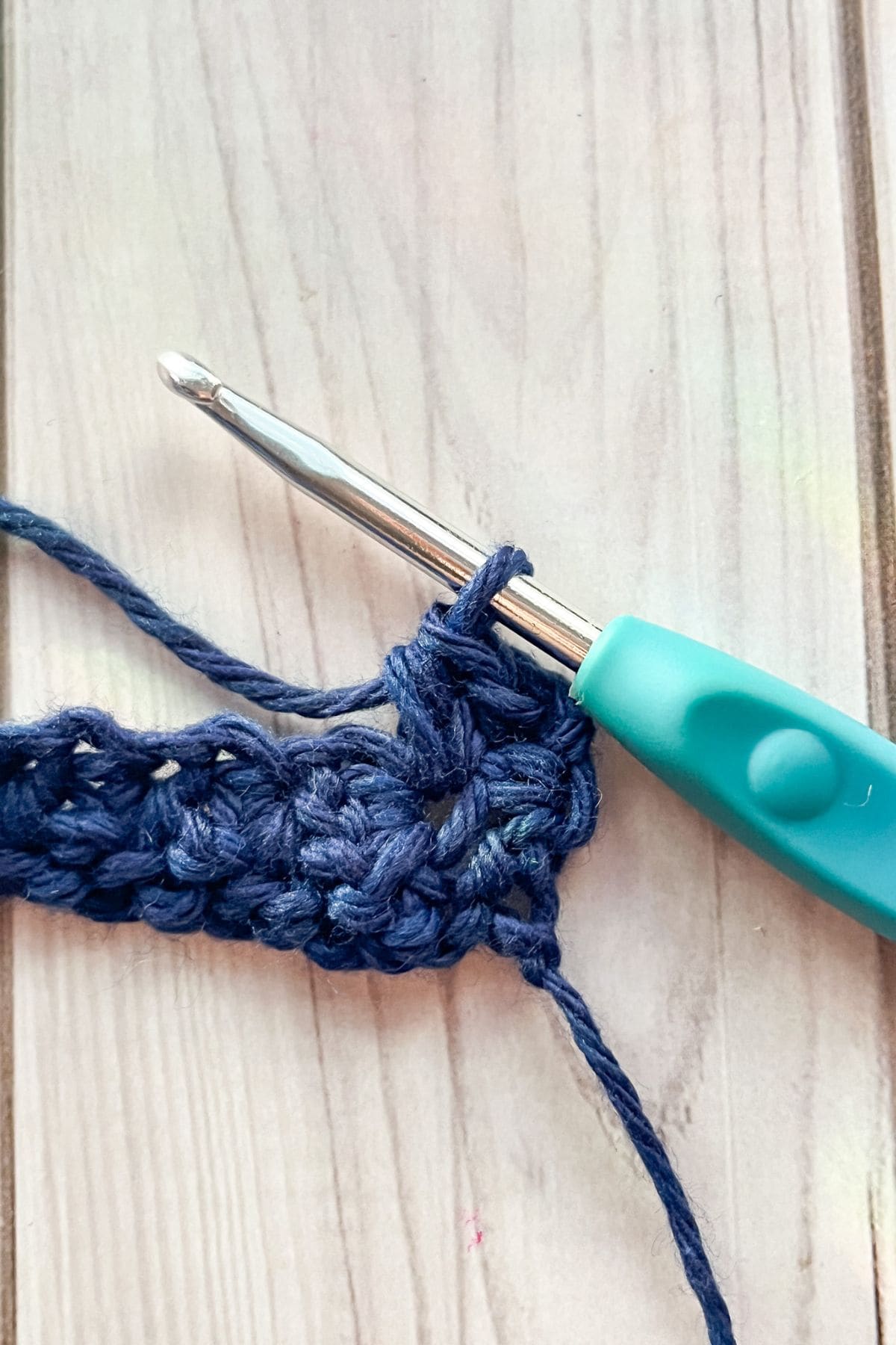 Working the second row of the crochet star stitch.
