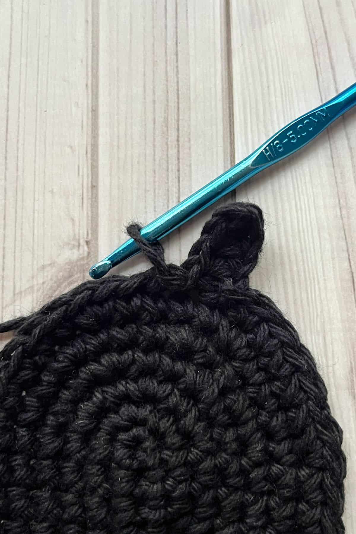 Crocheting the spider coaster.
