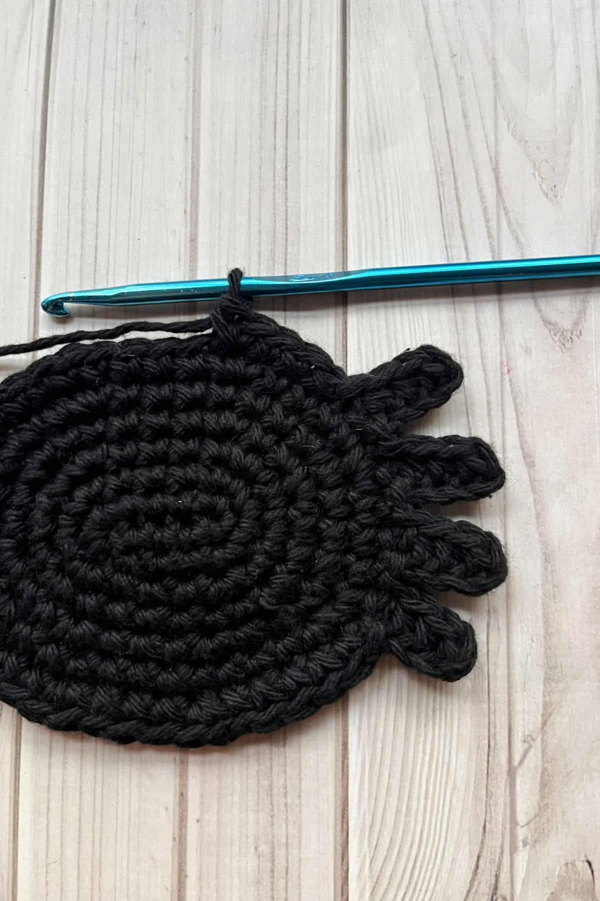 Crocheting the spider coaster.
