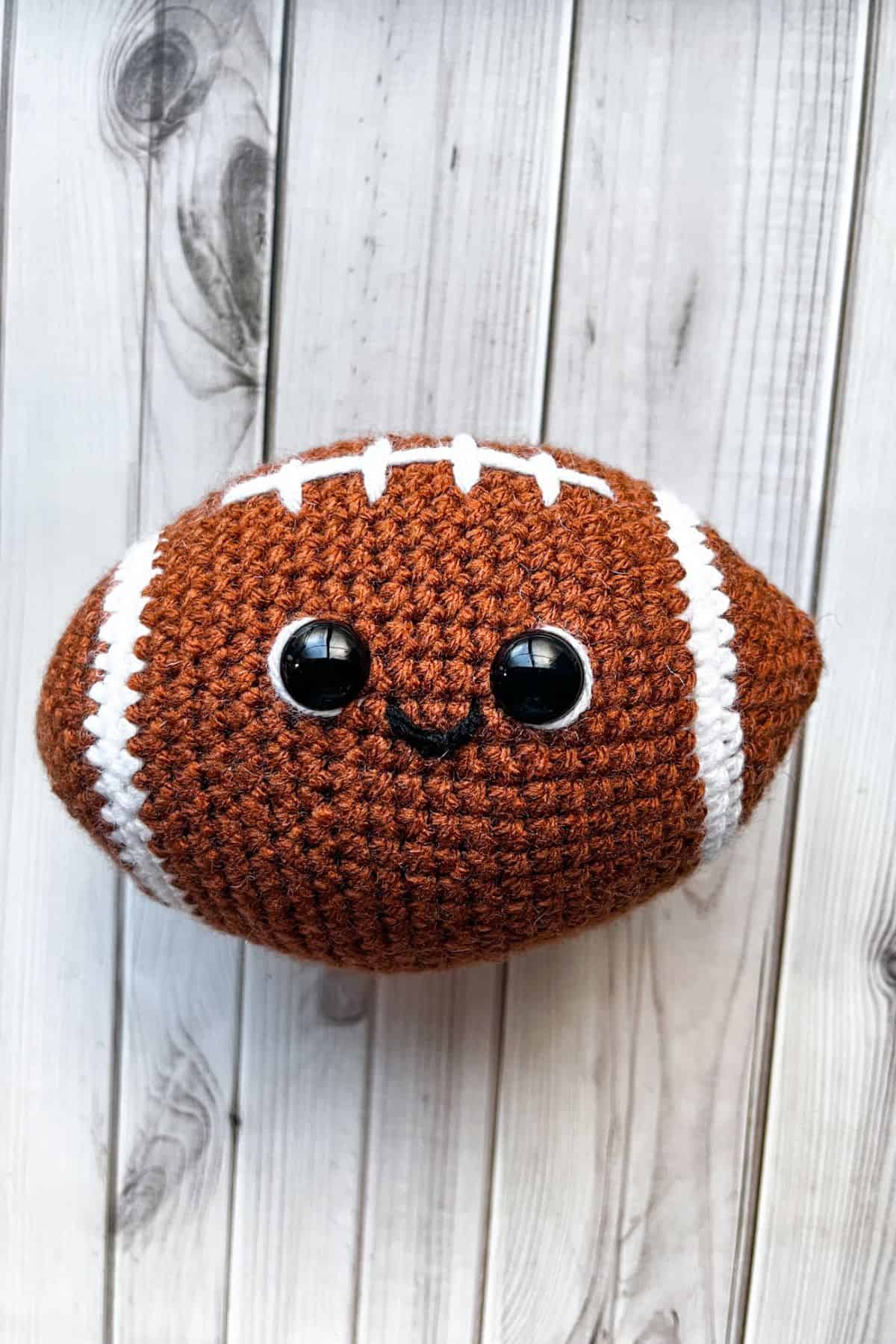 Finished crochet football plushie.