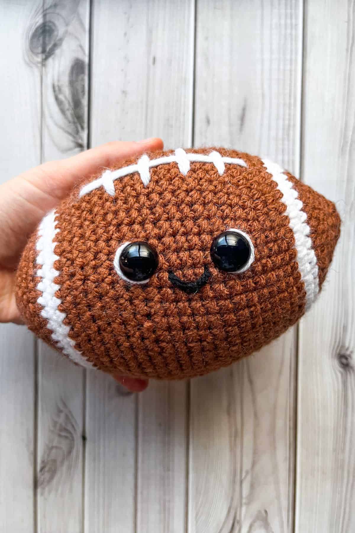 Finished crochet football plushie.