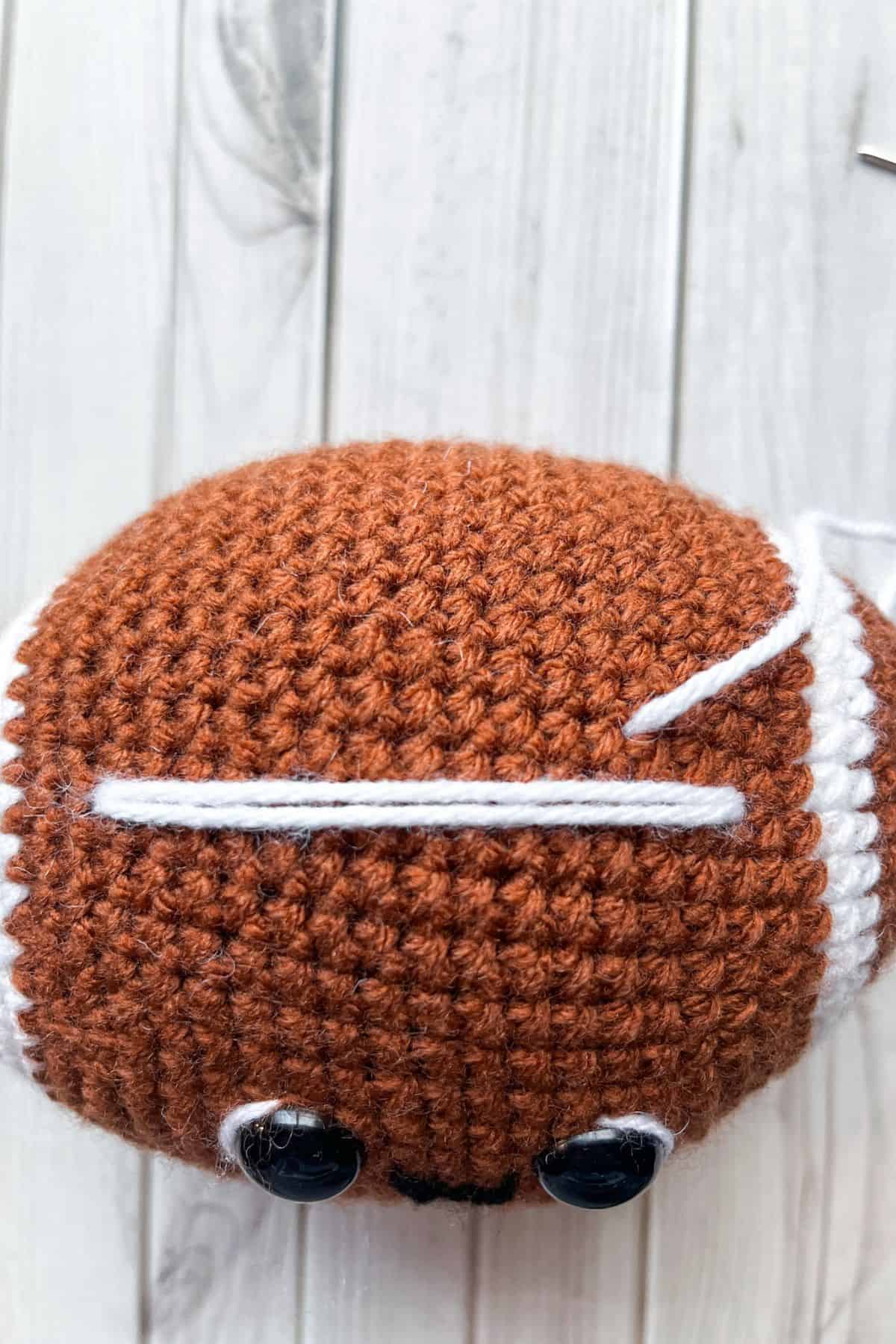 Embroidering the football stitch marks.