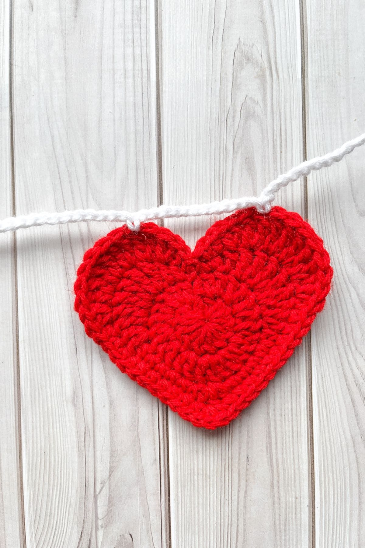 Connecting the hearts together to make a garland.