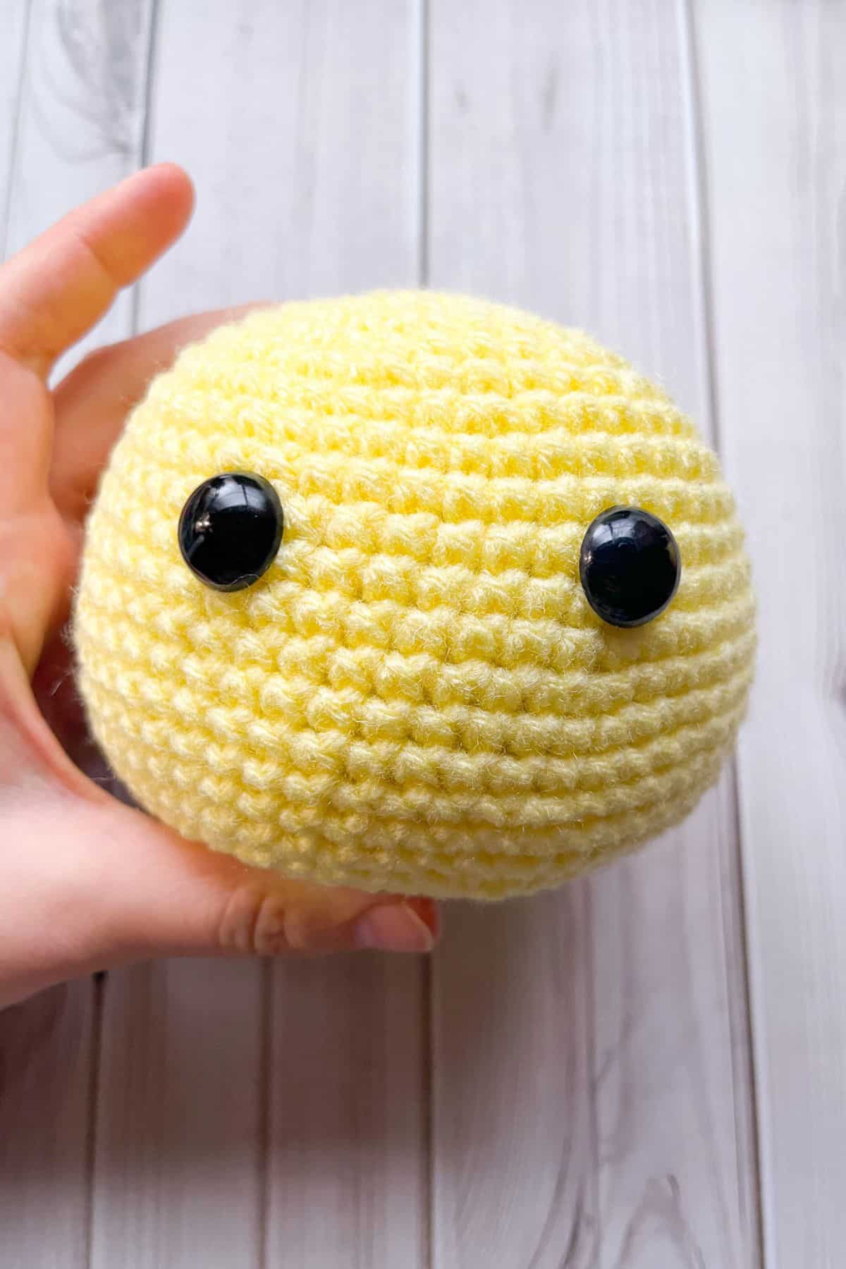 Crochet duck head on table.