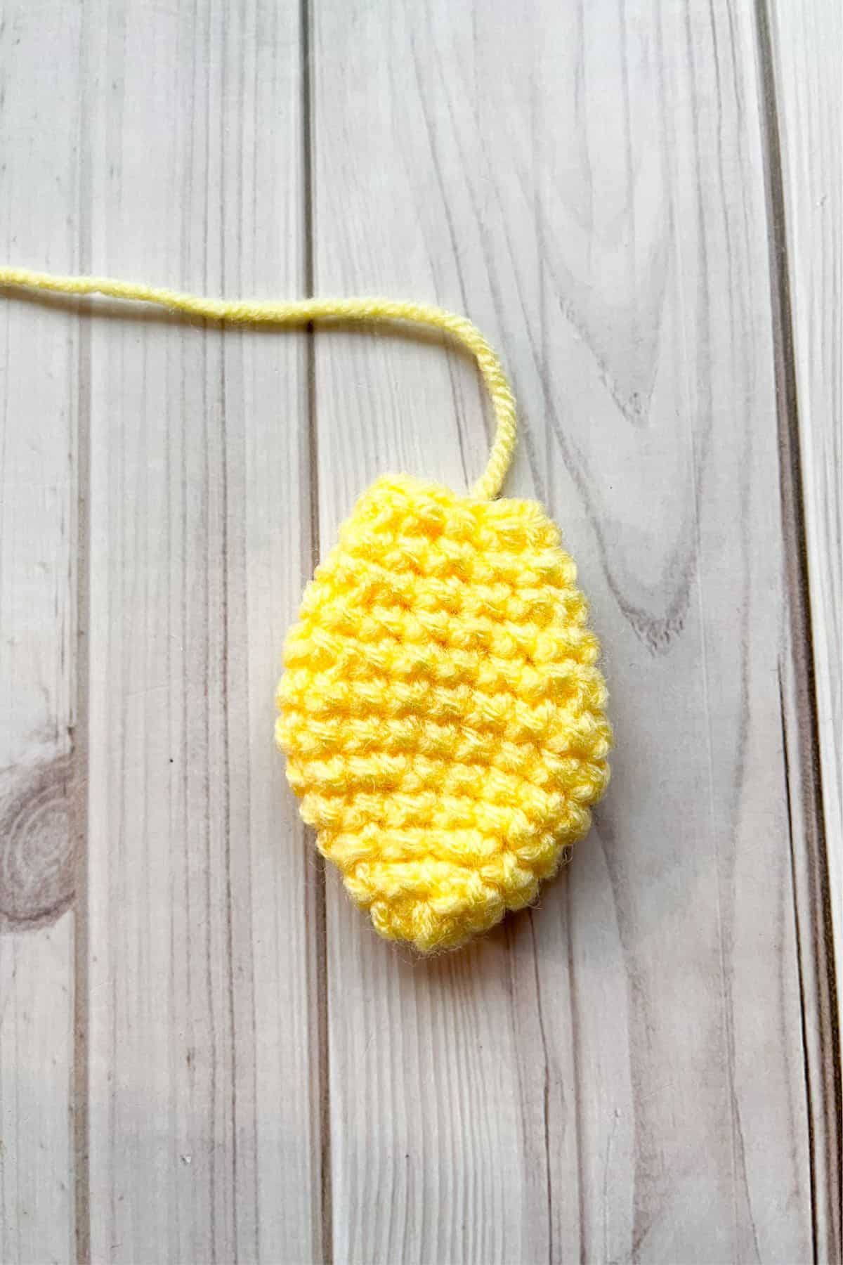 Crochet duck wing on table.