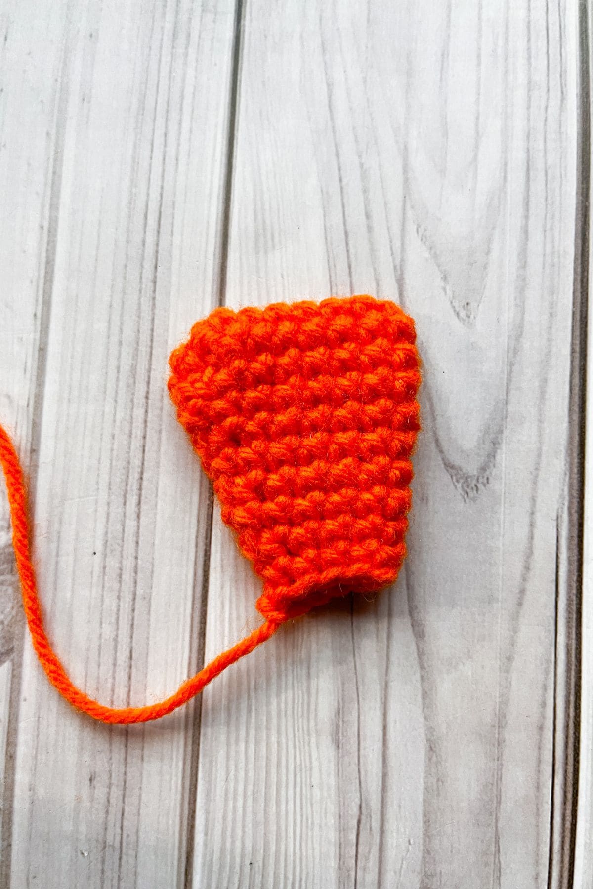 Crochet duck foot on table.