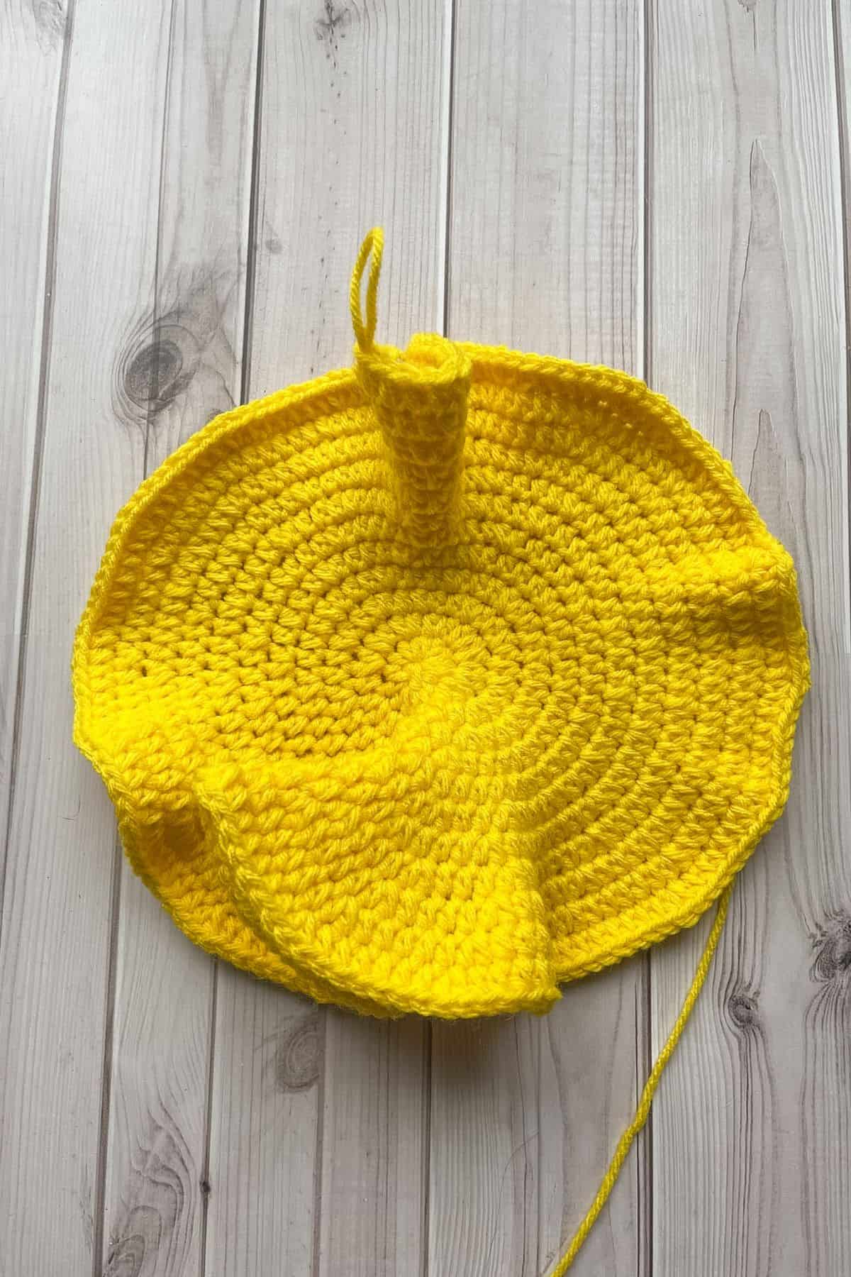 Showing the waviness of the crochet pillow.