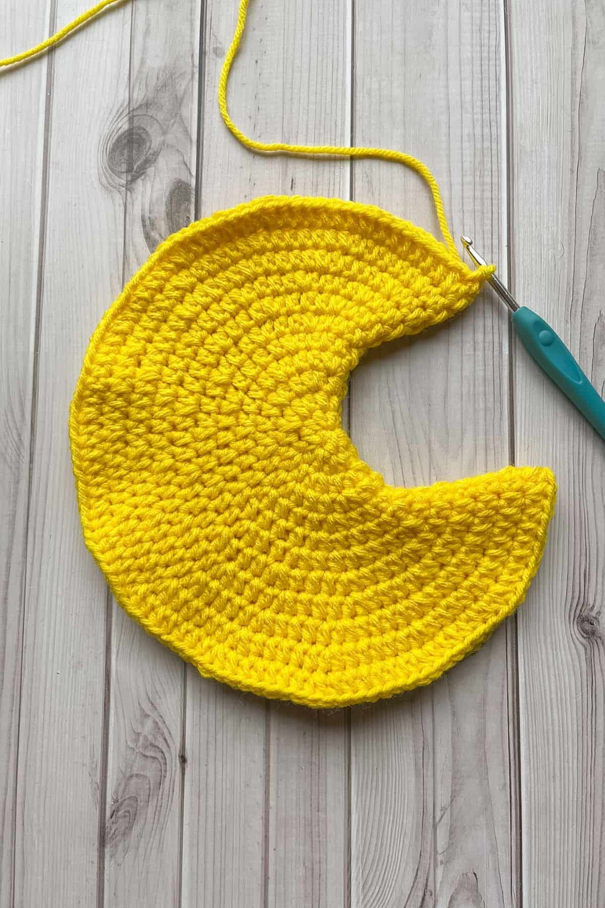 Folding the moon pillow in half to show the curve.