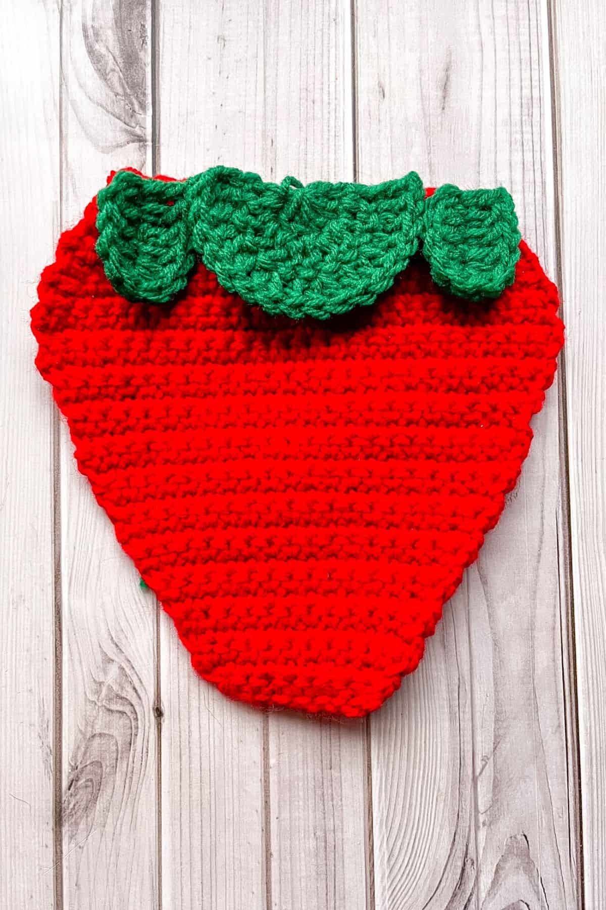 Showing where to attach the foliage to the top of the strawberry panel.
