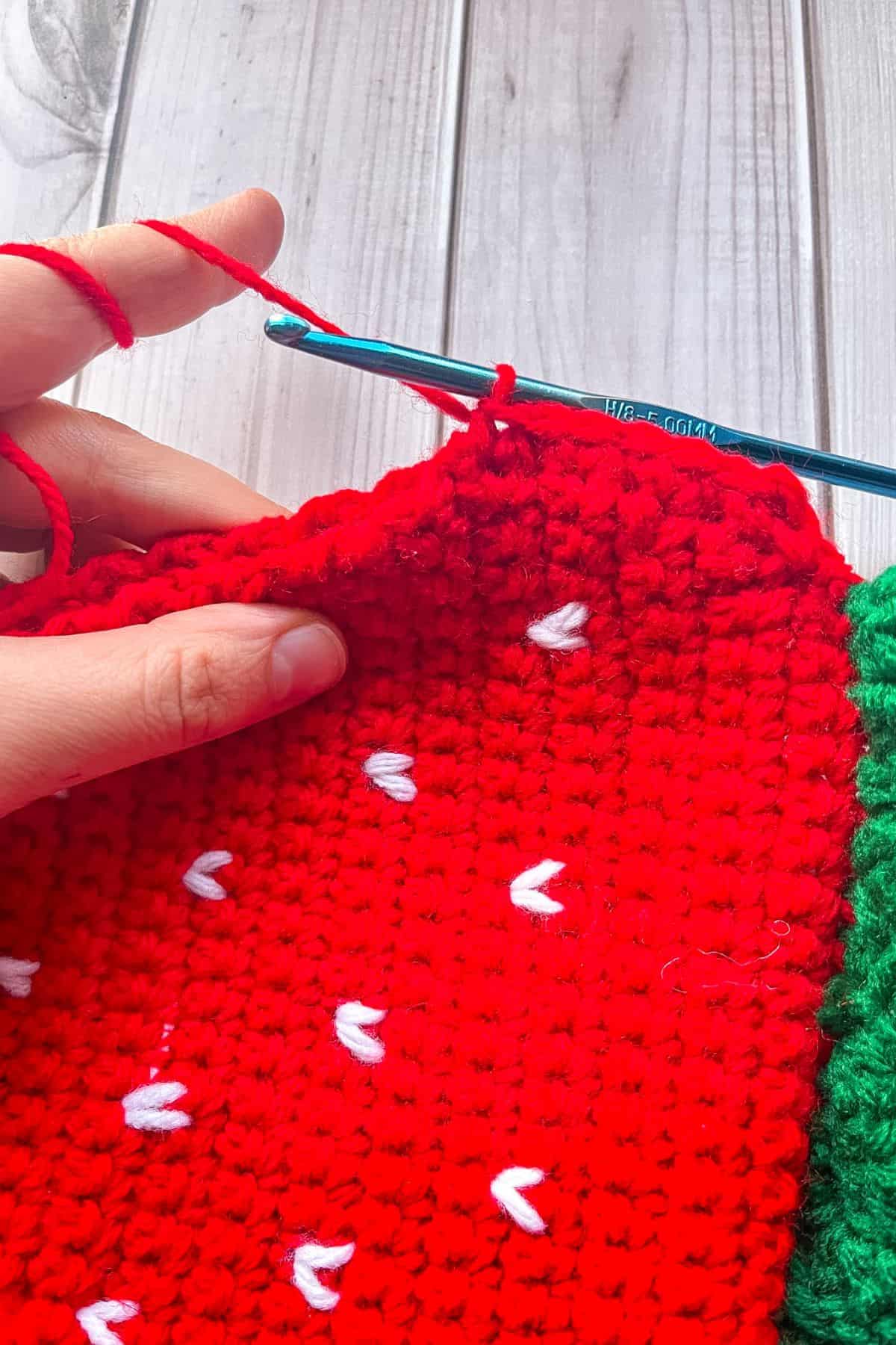 Close up of crocheting the bag and strap together.