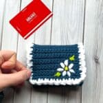 Finished crochet wallet with arcade gift card on table.