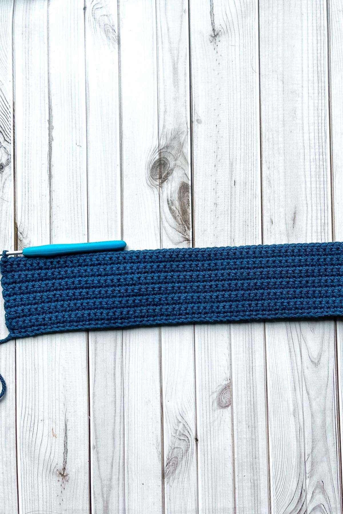 Flat base of the crochet wallet halfway done.