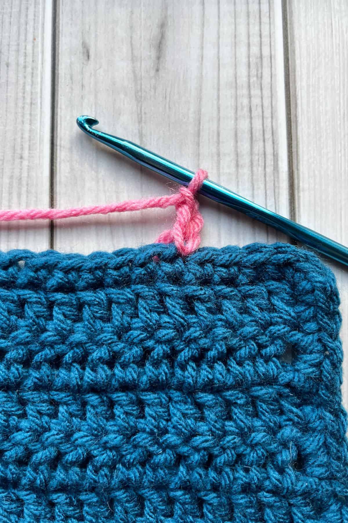 Starting the crochet border with pink yarn.