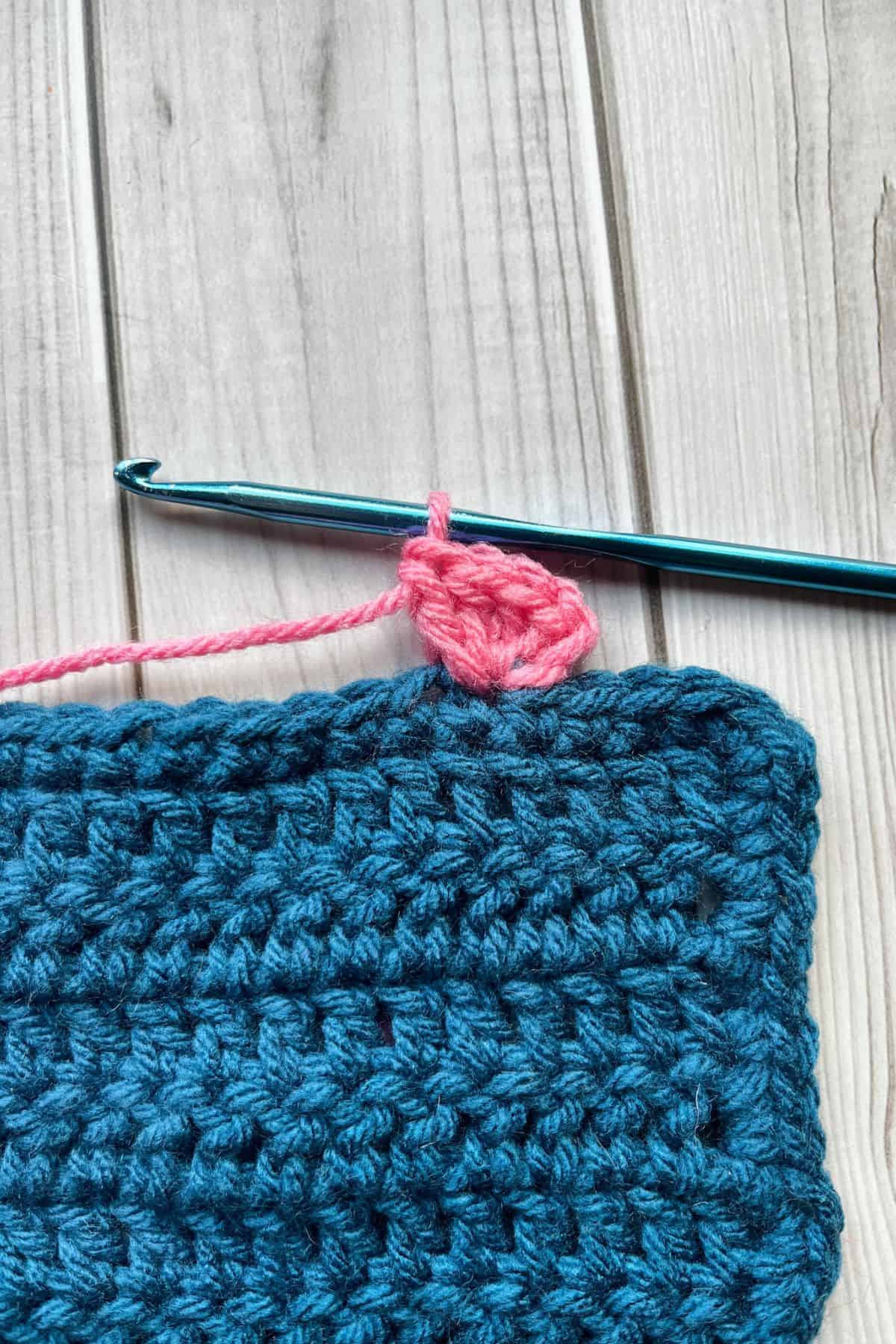 Starting the crochet border with pink yarn.