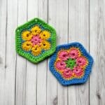 2 African flower hexagons lay on a table.