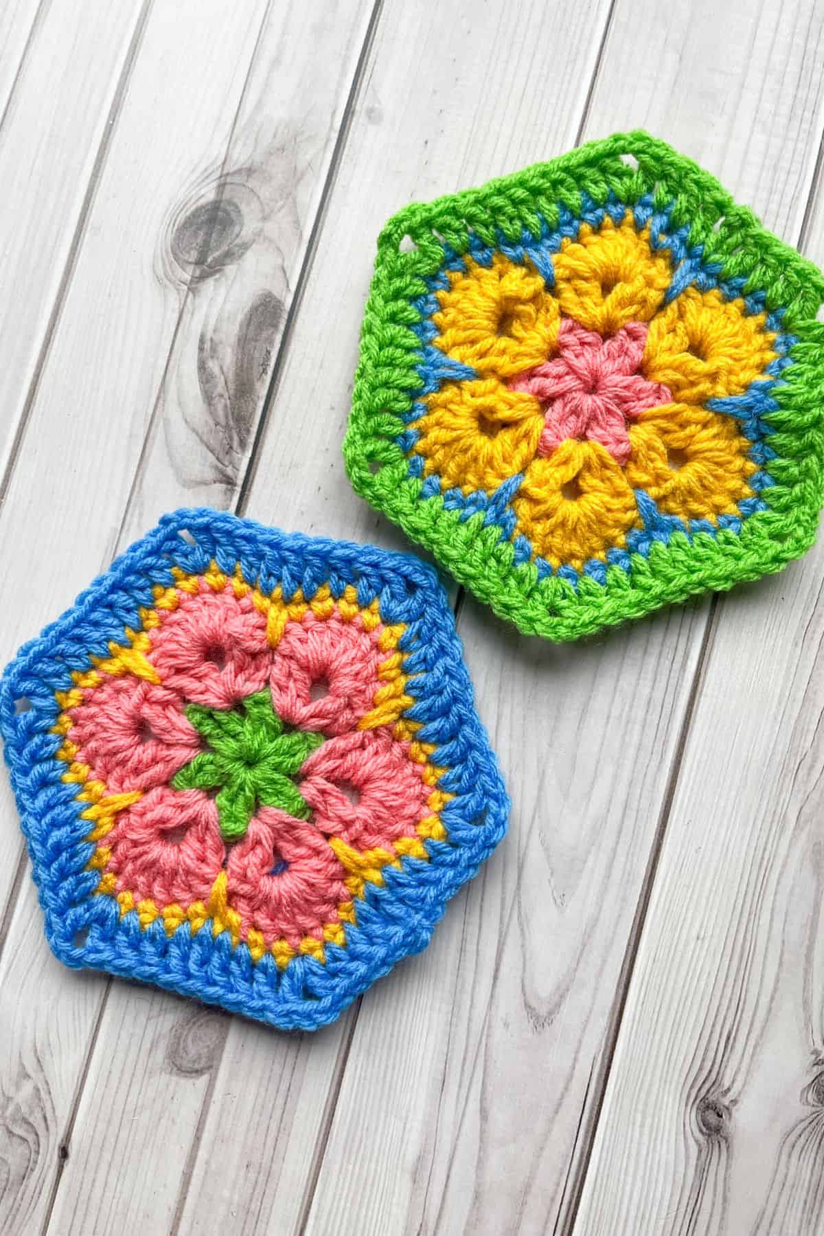 2 African flower hexagons lay on a table.