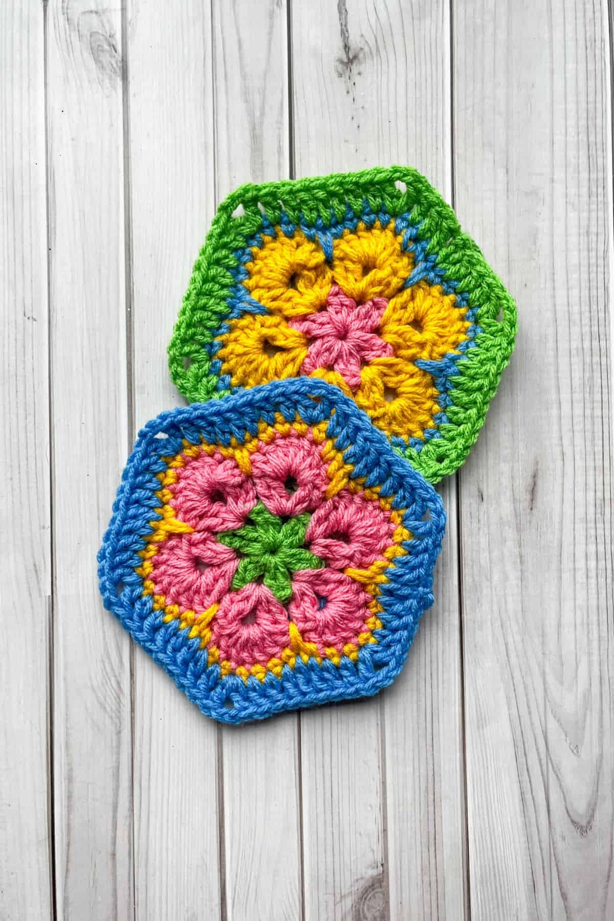 2 finished 6 petal African hexagons on table.
