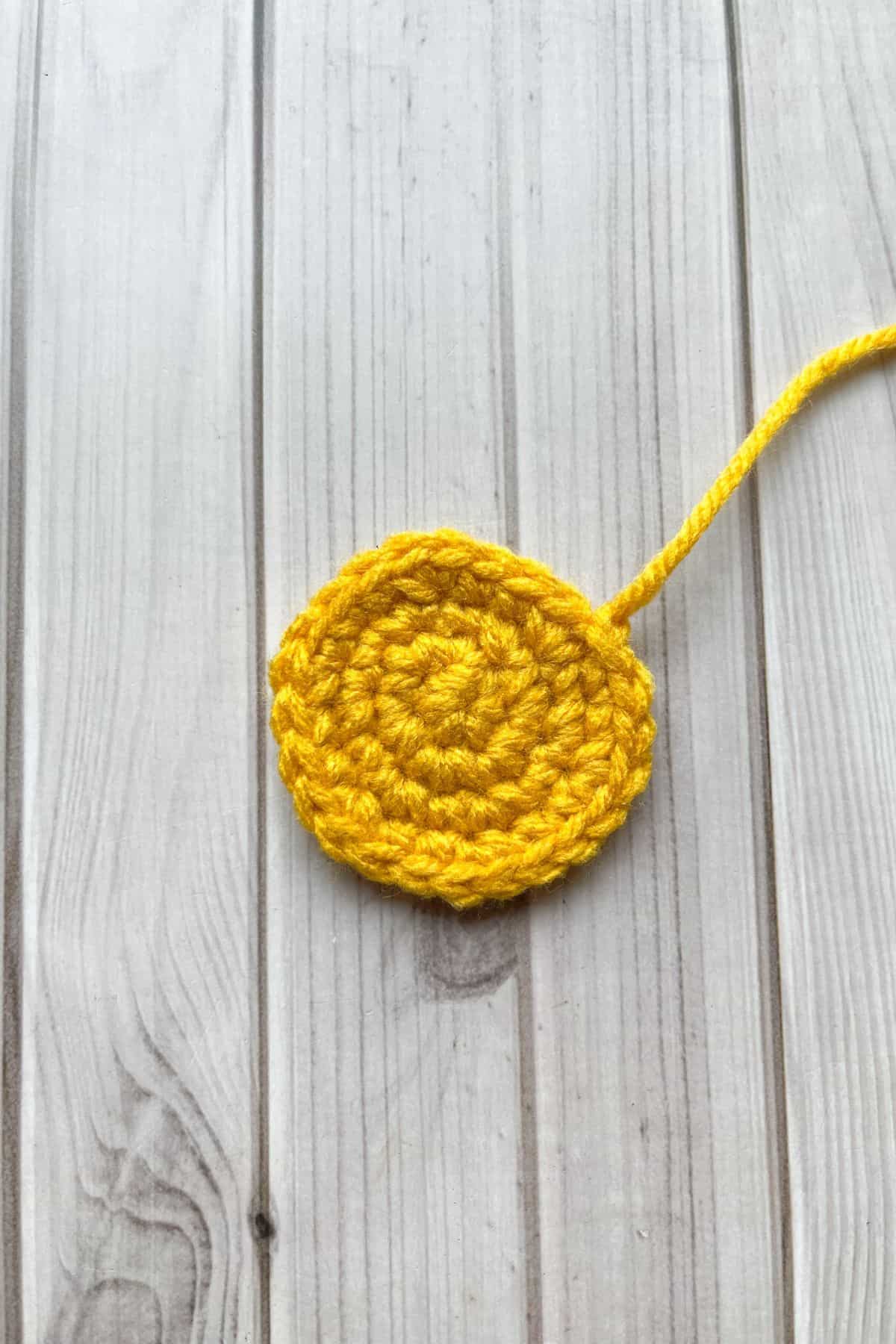 Yellow middle of daisy completed, laying on the table.