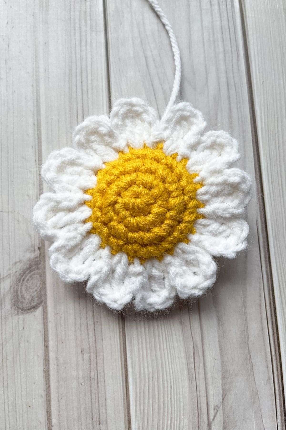 Finished crocheting the daisy keychain closed.