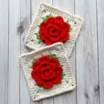2 finished crochet rose granny squares on a table.