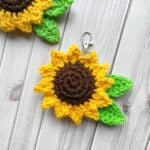 Finished crochet sunflower keychain on table.