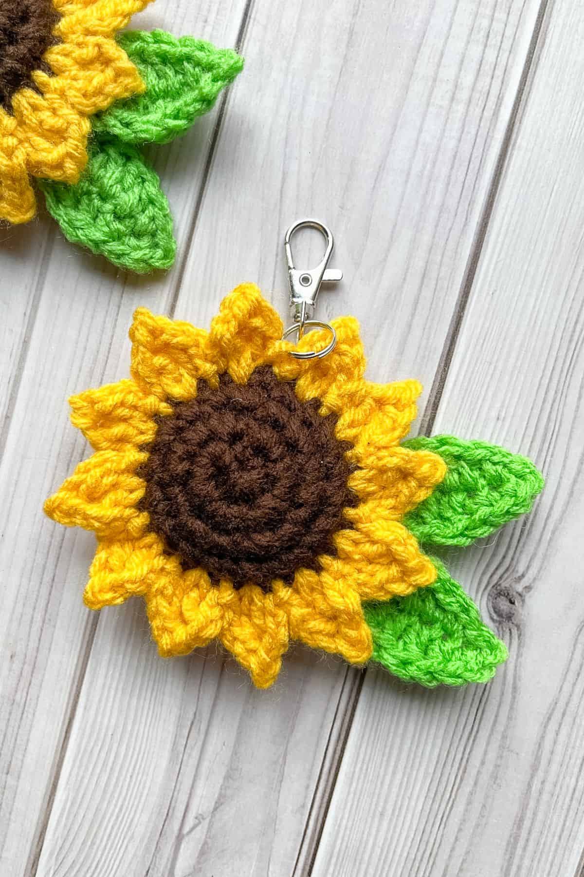 Finished crochet sunflower keychain on table.