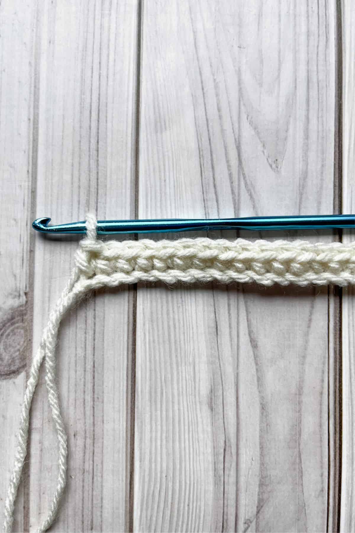 First row of the tulip stitch is completed and on the table with hook.
