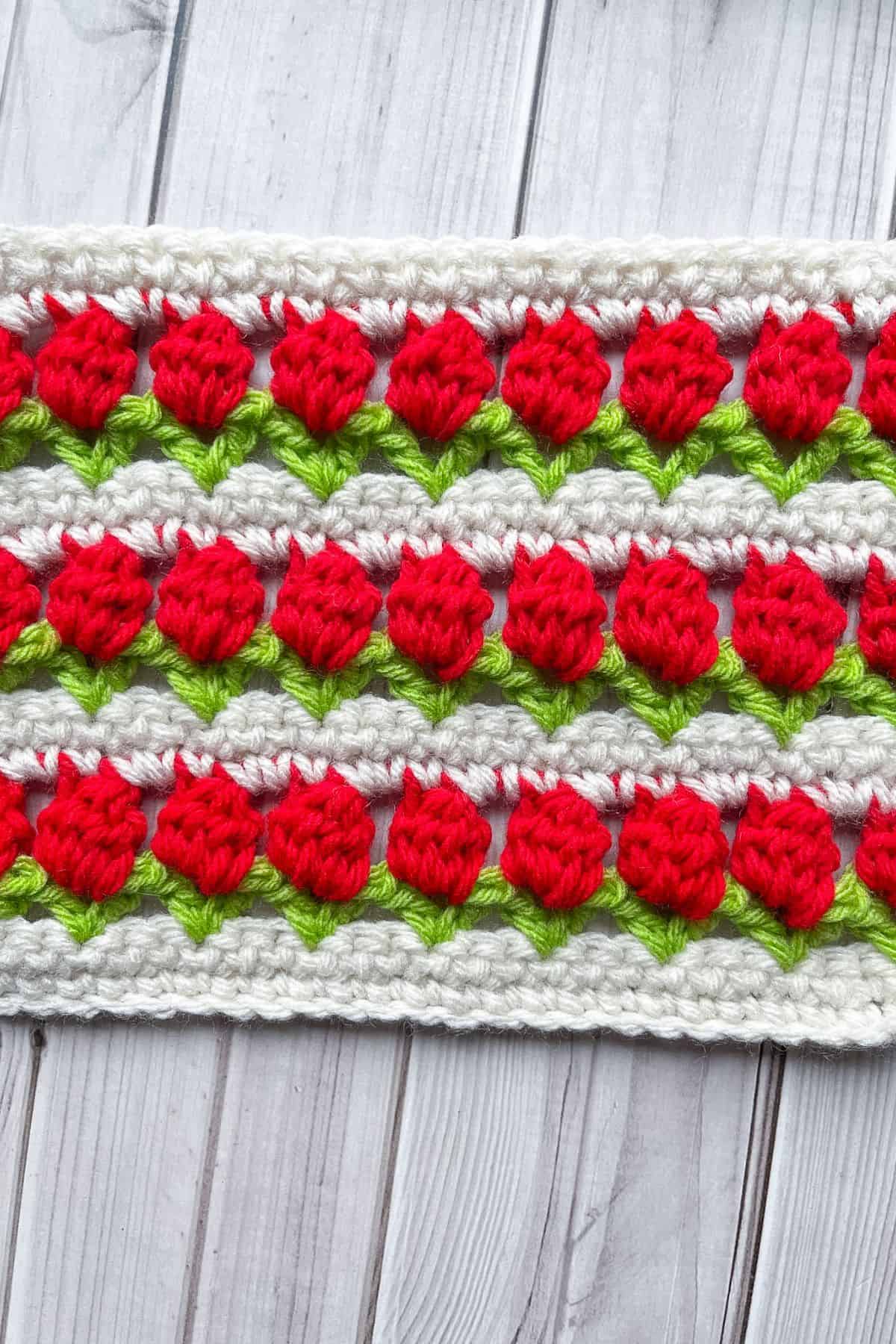 Finished crochet tulip swatch on table.
