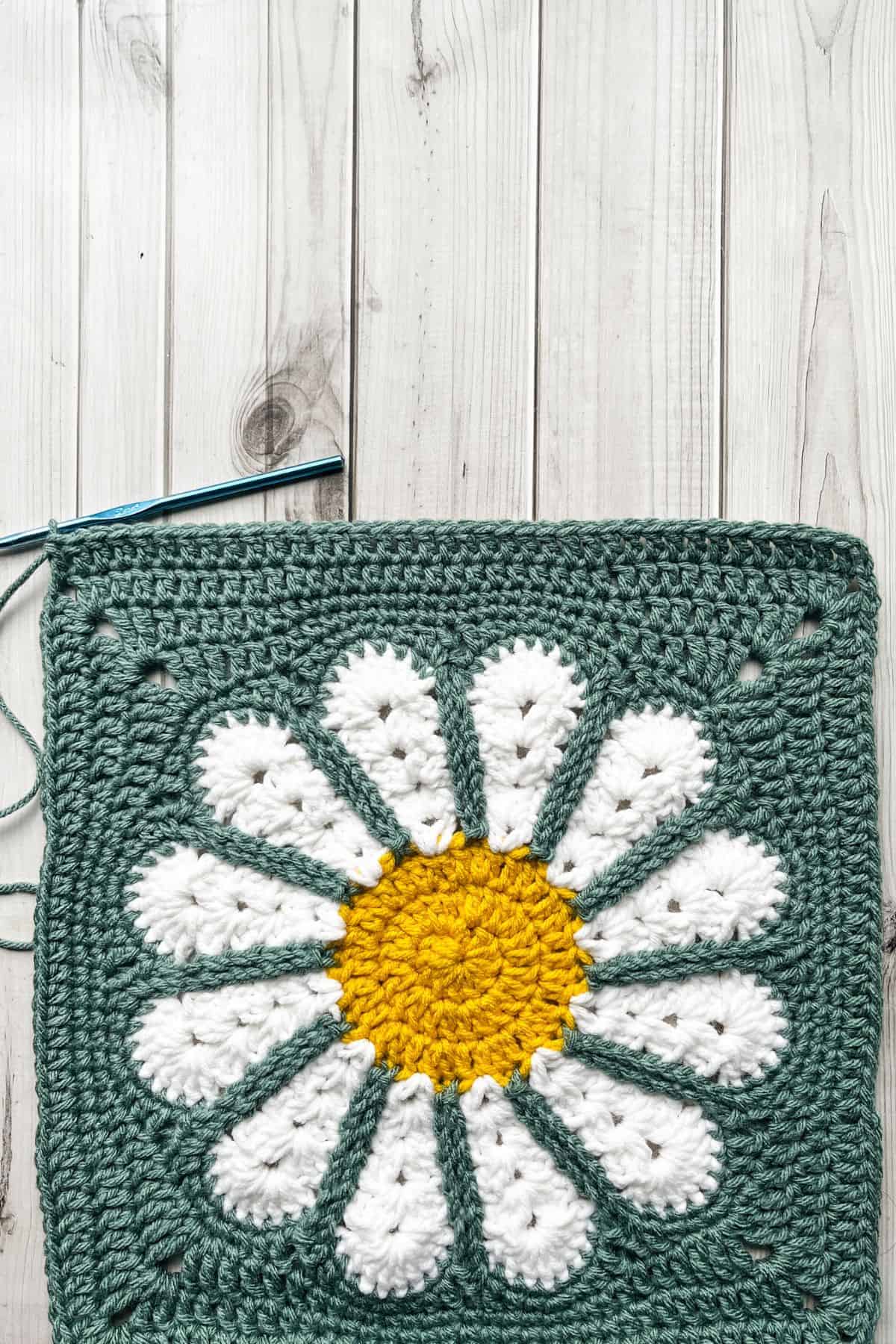 Double crocheting across 1 side of the granny square.