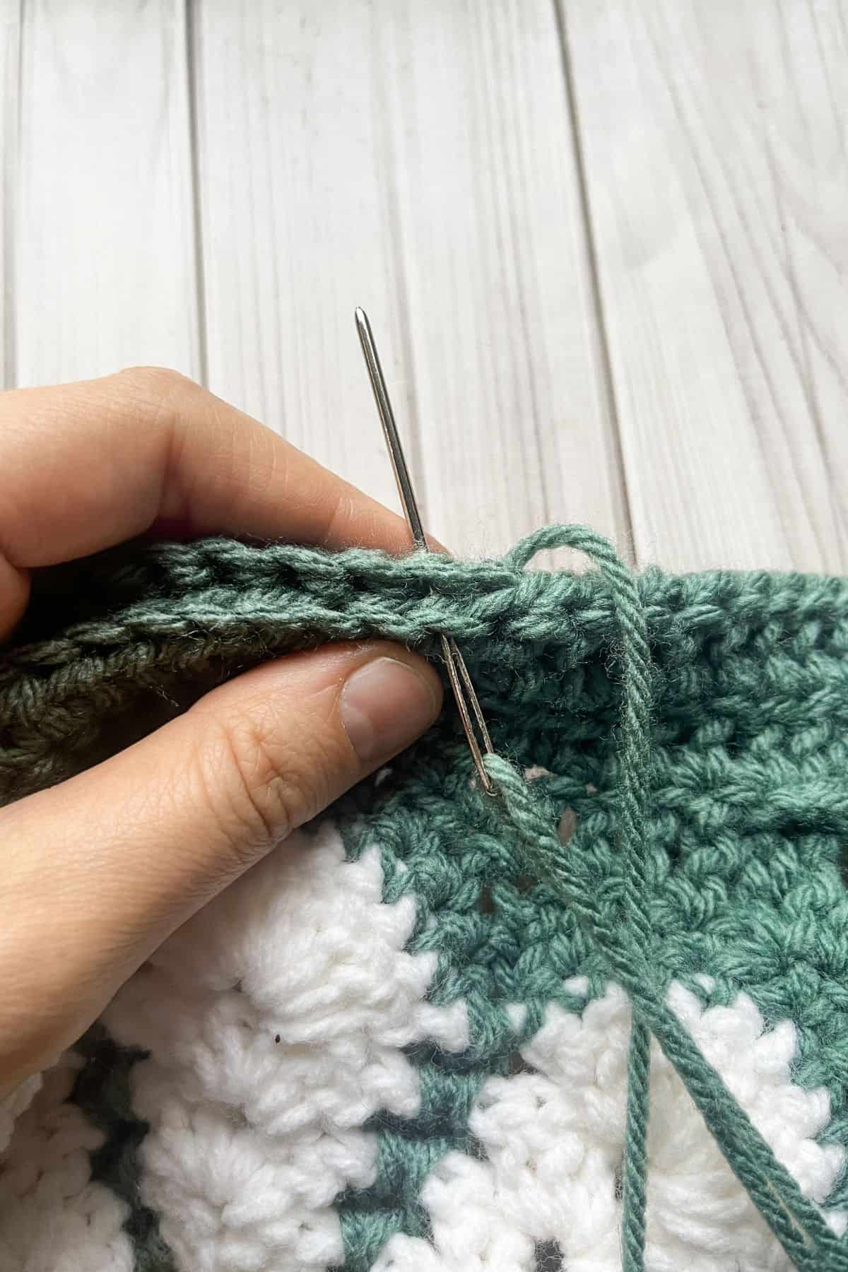 Hands sewing the bag together.