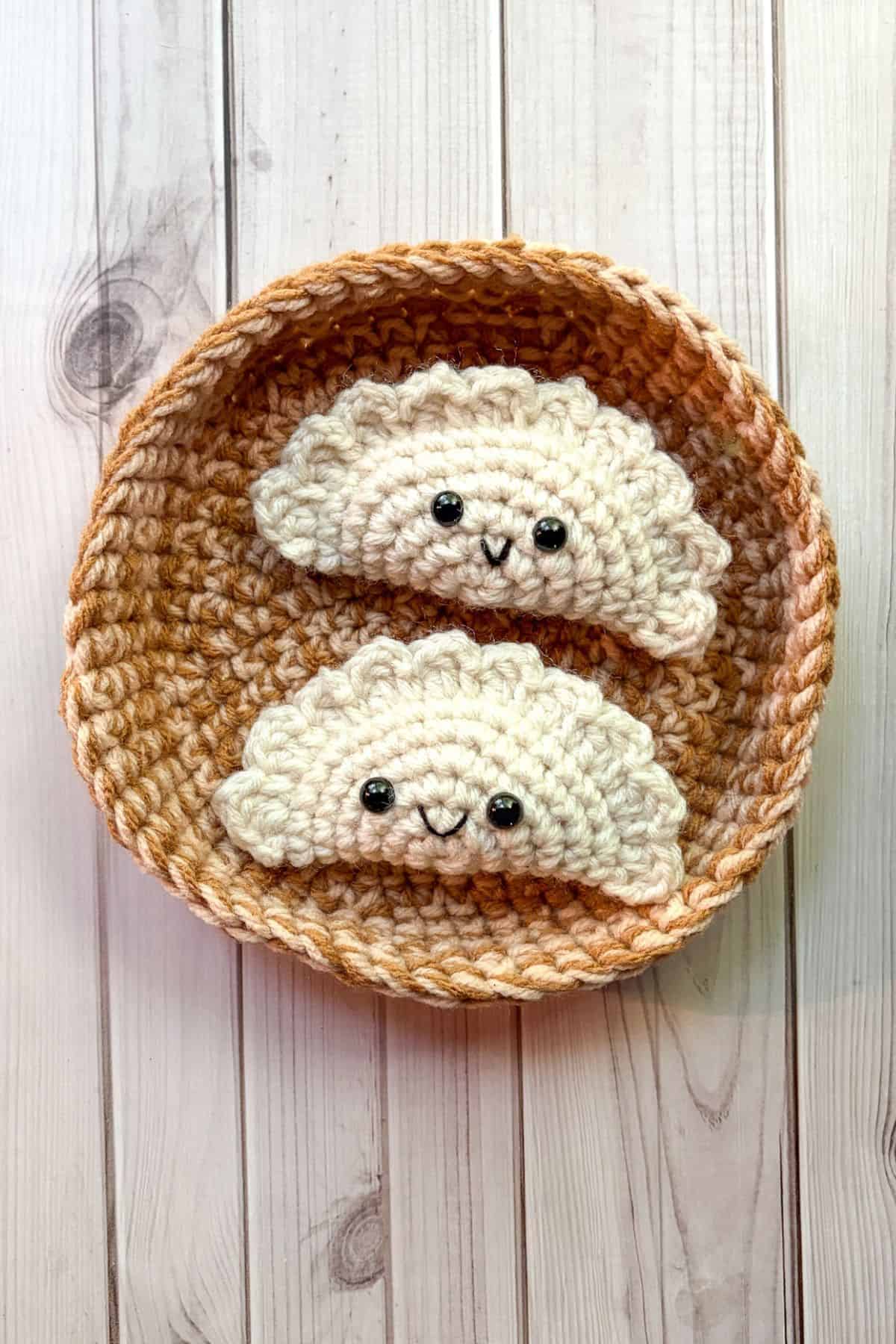 2 finished crochet dumplings in a steamer basket.