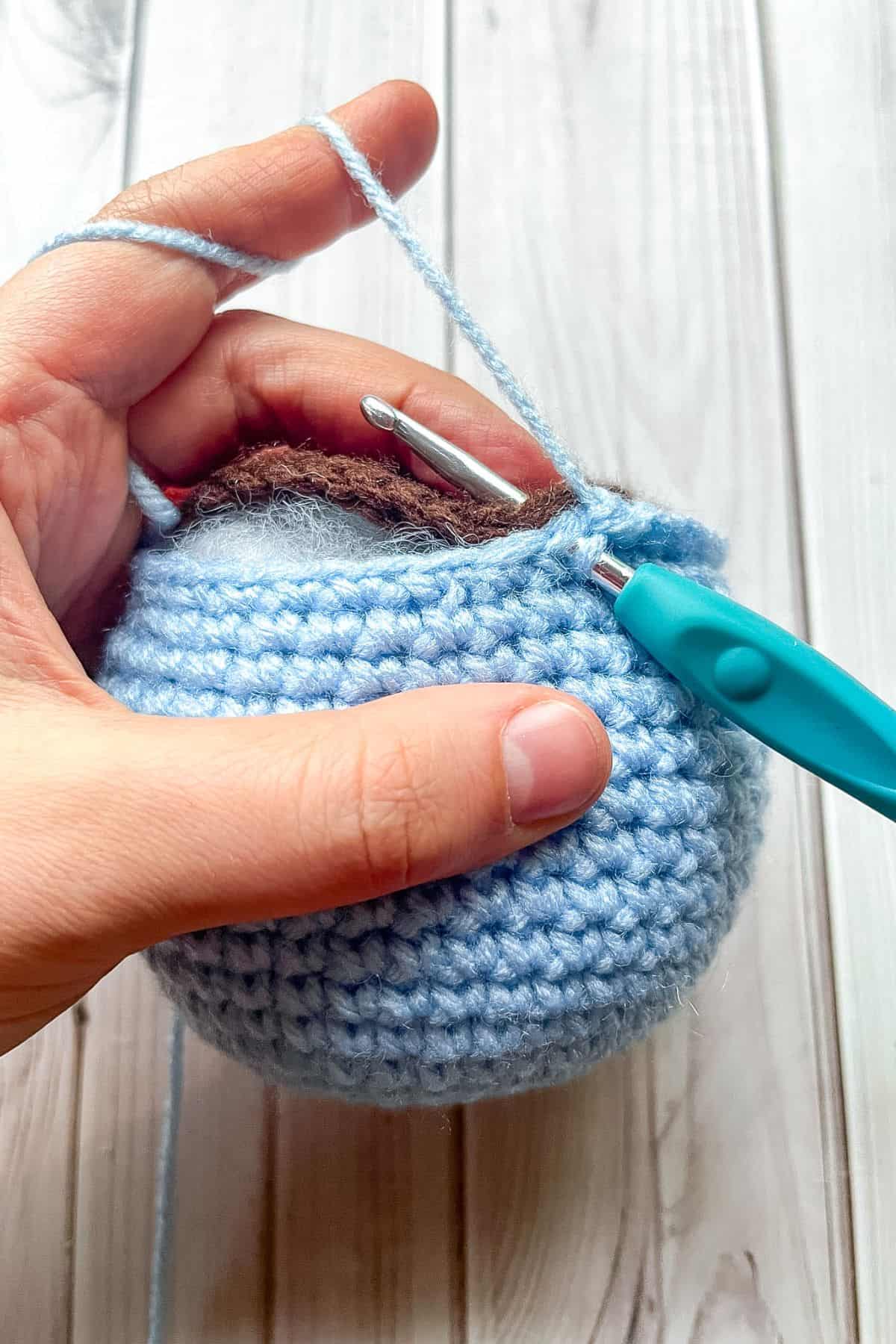Crocheting the flowerpot and soil together.