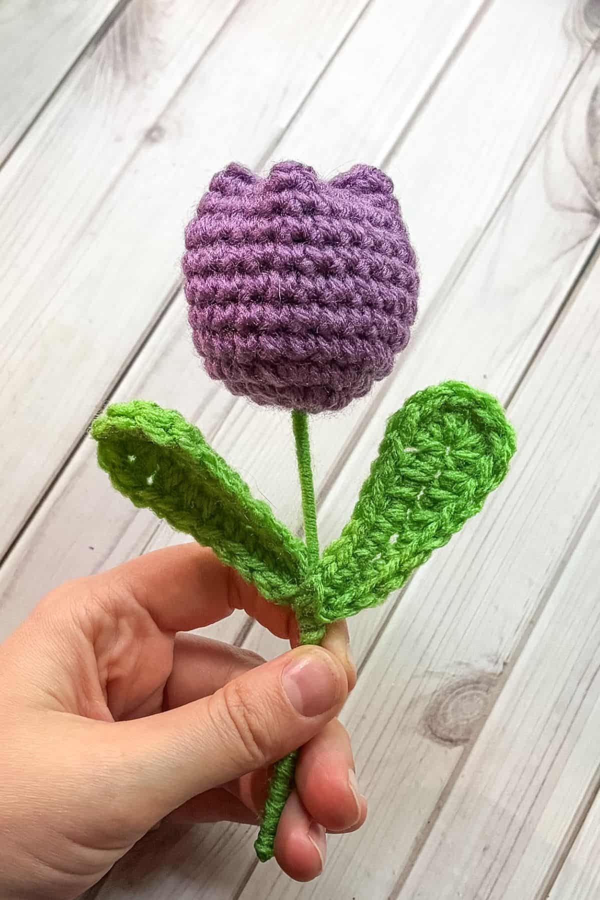 Finished crochet tulip in hand.