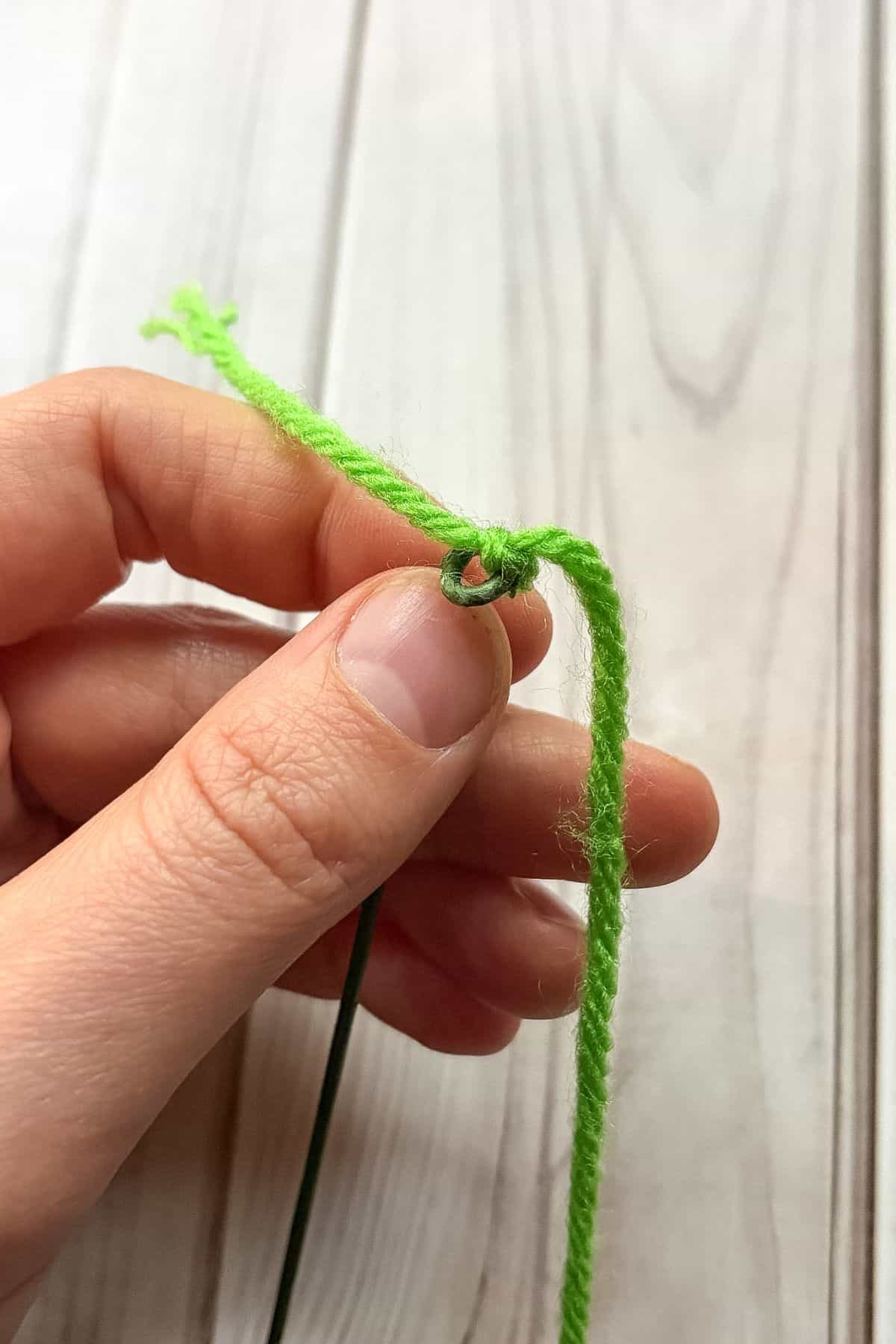 Where to attach the green yarn to the wire.