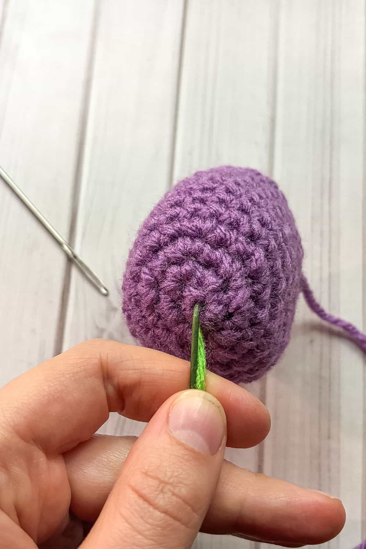 Where the wire and yarn poke through the bottom of the tulip.
