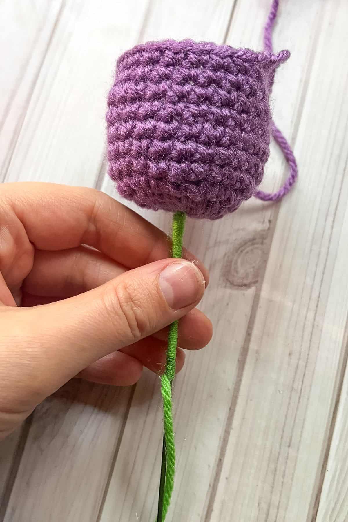 Wrapping the wire with yarn.