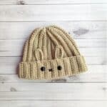 Finished crochet bunny hat on table.