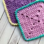 Finished crochet granny squares with crab stitch border.