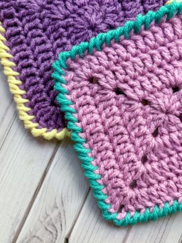Finished crochet granny squares with crab stitch border.