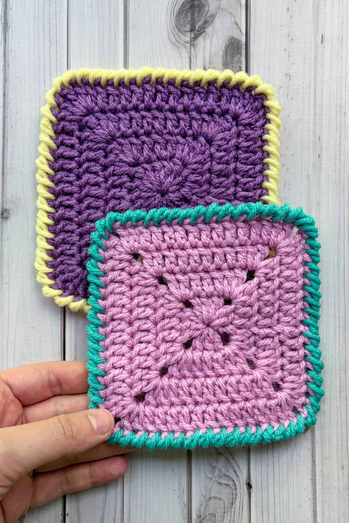 Finished crochet granny squares with crab stitch border.