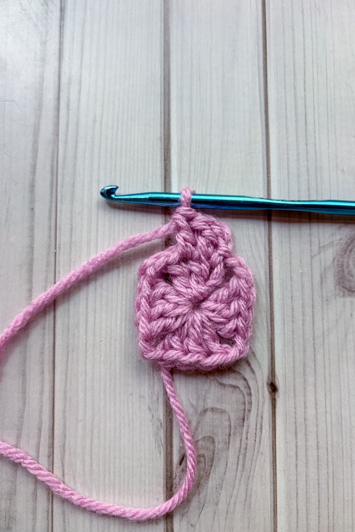 Working on the second round of the solid granny square.