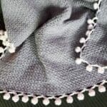 Finished crochet linen stitch blanket on couch.